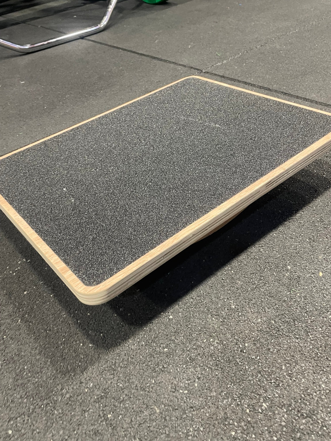 Wooden rocker balance board angled side view