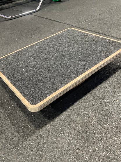 Wooden rocker balance board angled side view