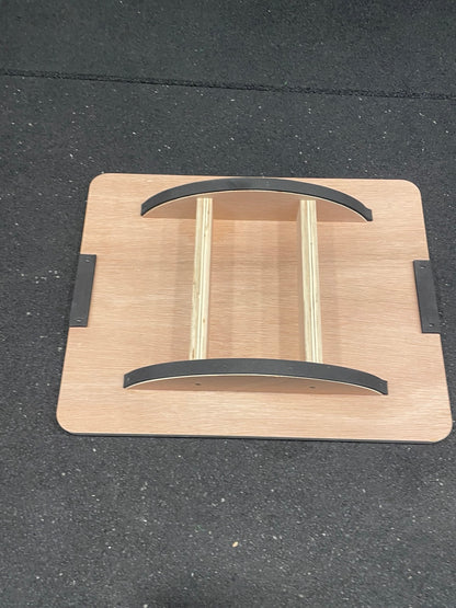 Underside of wooden rocker balance board