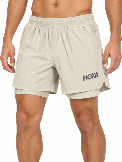 Men's beige layered running shorts on model