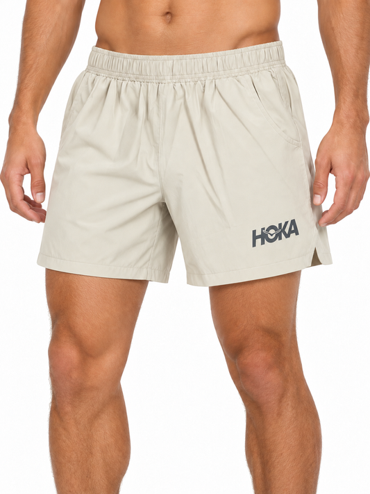 Men's beige HOKA running shorts on model