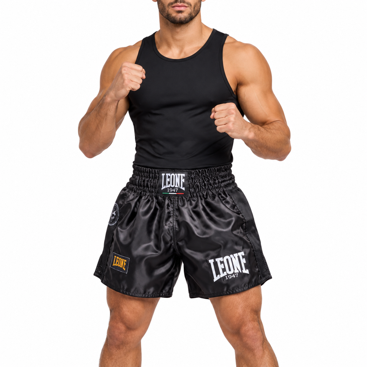 Male model wearing black Leone Muay Thai shorts